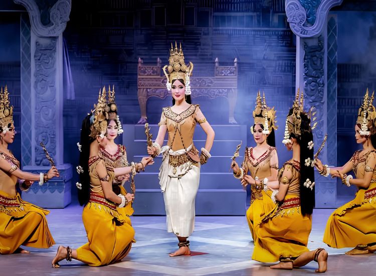 Cambodian Apsara dancers performing on stage in traditional golden costumes and elaborate headdresses in Siem Reap.