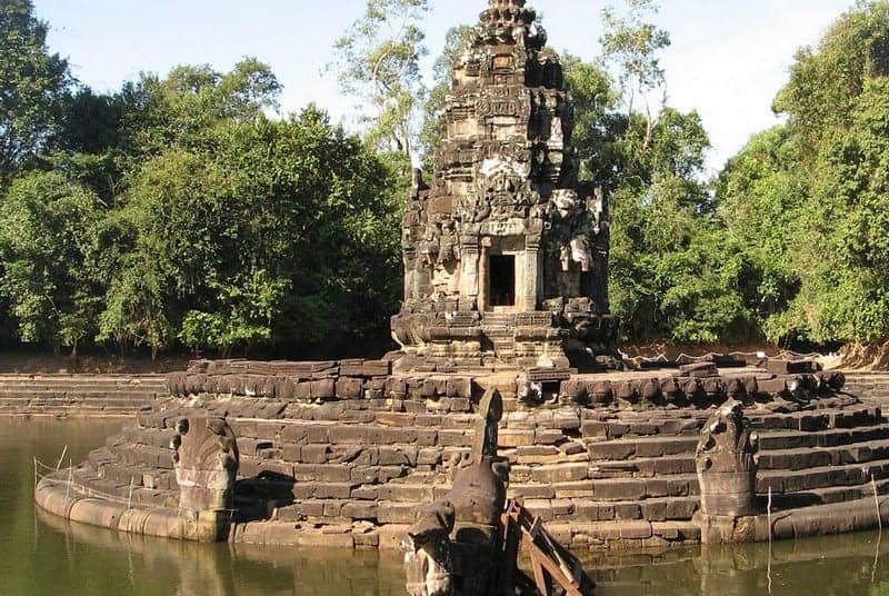 Ancient stone island temple of Neak Pean surrounded by a water pond in Siem Reap Cambodia