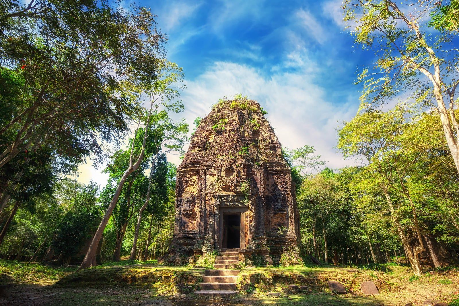 Ancient pre-Angkorian brick temple tower surrounded by lush forest at Sambor Prei Kuk in Kampong Thom Cambodia