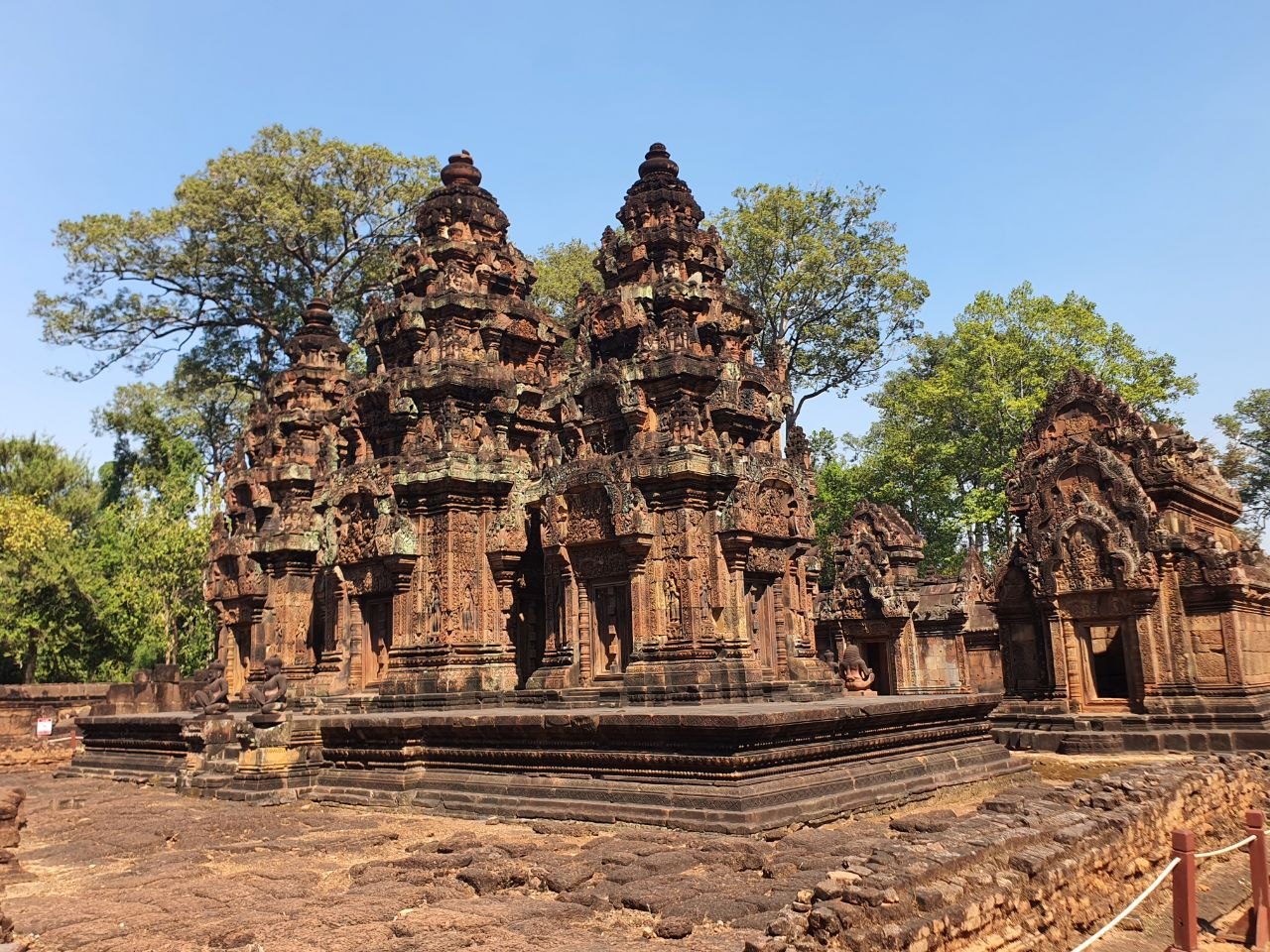 Intricately carved pink sandstone towers of Banteay Srei temple in Siem Reap Cambodia