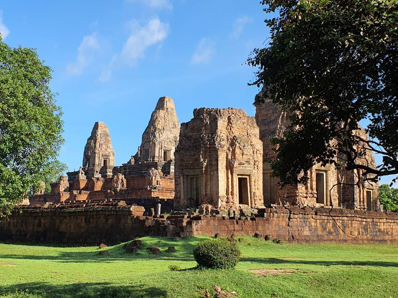 Ancient stone towers of Pre Rup temple mountain against a clear blue sky in Siem Reap Cambodia