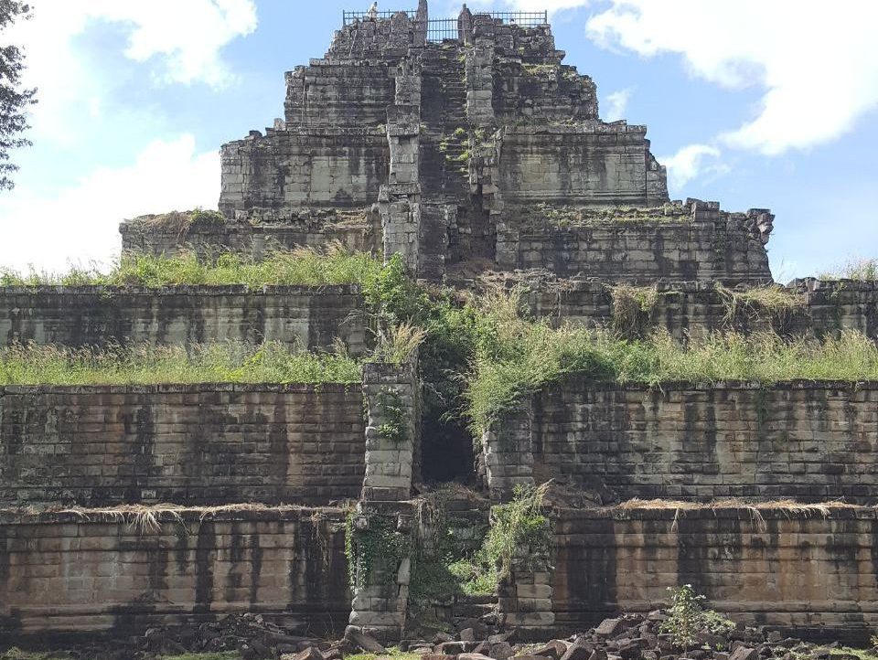 Ancient seven-tiered stone pyramid temple of Prasat Prang at Koh Ker complex in Cambodia under a blue sky