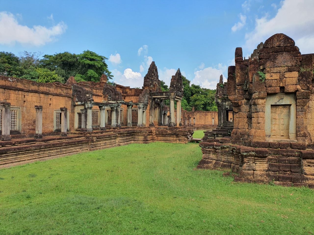 Ancient reddish laterite stone walls and gallery corridors of Banteay Samre temple in Siem Reap, Cambodia